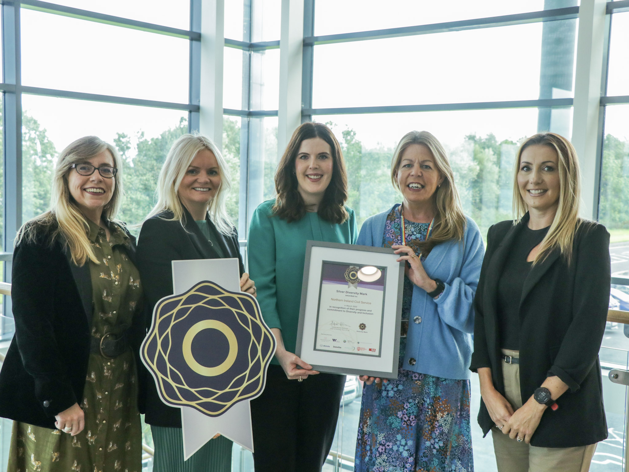 A group of female NICS colleagues receiving the Silver Diversity mark award